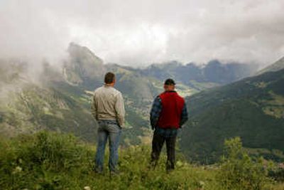 
Above, men look from the mountains of Abondance in the French Alps on Wednesday to the valley below. The town of Abondance has voted to close its ski operations because of declining snow.  
 (Associated Press photo / The Spokesman-Review)