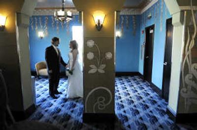 
Kelli and Andrew Whitecar find a quiet moment in the lobby balcony of the renovated Fox Theater after exchanging vows on June 14. 
 (Christopher Anderson / The Spokesman-Review)