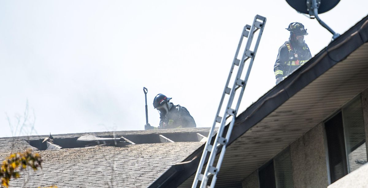 City fire fighters work to put out a fire that started on the third floor of this apartment building on Pacific Avenue in Browne's Addition on Friday, August 4, 2017. (Kathy Plonka / The Spokesman-Review)