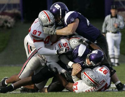 
Northwestern's Mike Kafka is sacked by Ohio State defender David Patterson (97) on Saturday.
 (Associated Press / The Spokesman-Review)