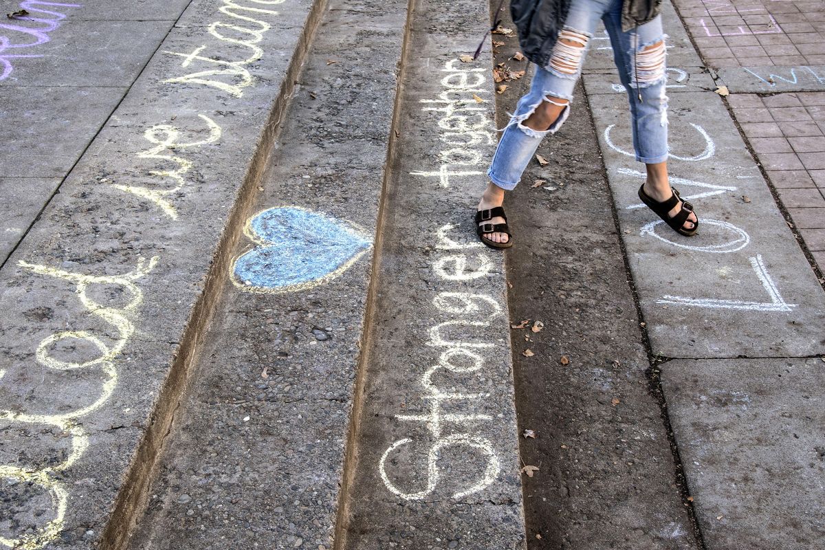 Chalk messages touting unity cover the steps in front of the Crosby Center on the Gonzaga University campus, Friday, Nov. 11, 2016, in Spokane, Wash. (Dan Pelle / The Spokesman-Review)