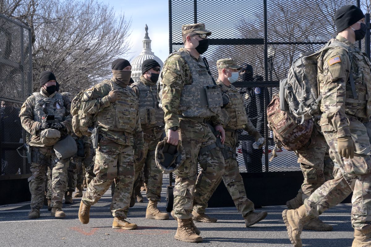 With the U.S. Capitol in the background, members of the National Guard change shifts as they exit through anti-scaling security fencing on Saturday, Jan. 16, 2021, in Washington as security is increased ahead of the inauguration of President-elect Joe Biden and Vice President-elect Kamala Harris.  (Jacquelyn Martin)