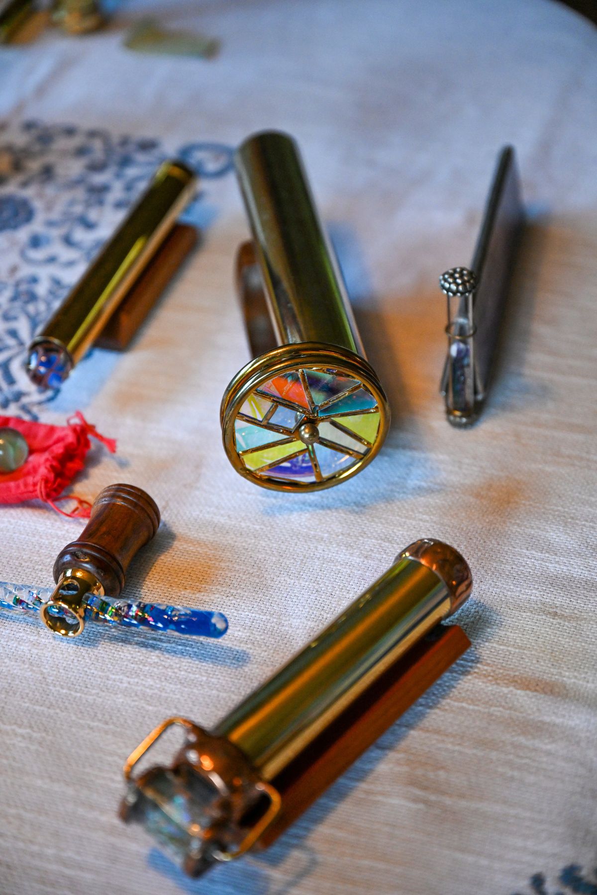 Jan Abrams of Spokane displays her collection of kaleidoscopes, which she has gathered over many years, on her kitchen table. She has everything from handmade works of art to simple cardboard tubes fitted with mirrors. She had to downsize her collection when she moved into retirement housing, but has still has many. Kaleidoscopes, invented in the early 1800s, have been a source of amusement based on how they produce varying colors and patterns to watch.  (Jesse Tinsley/THE SPOKESMAN-REVIEW)
