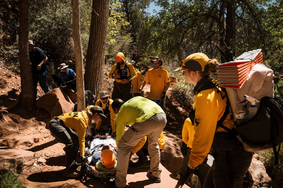 A search and rescue team assists a park visitor injured on a trail on Aug. 18 at Zion National Park in Utah. The park’s search and rescue team is about 10% smaller than it was a year ago (New York Times)