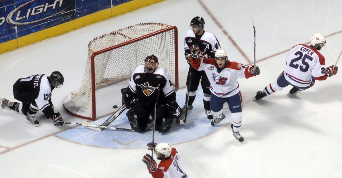 Mitch Wahl, second from right, celebrates Tyler Johnson’s goal at 5:38 of the first period to open the scoring. (J. Bart Rayniak / The Spokesman-Review)