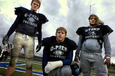 
Spencer Savage, center, is flanked by A.J. Allen, left, and Cameron McMillan. Ian Orlando completes the defensive line. 
 (Jed Conklin / The Spokesman-Review)