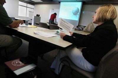 
University of Phoenix student Lynn Nolen, right, talks with her classmates Thursday before an MBA economics discussion. 
 (Christopher Anderson/ / The Spokesman-Review)