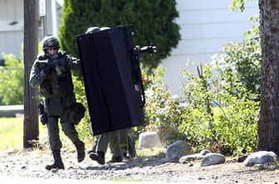
SWAT team members prepare to enter a house Sunday in Millwood. 
 (Liz Kishimoto / The Spokesman-Review)