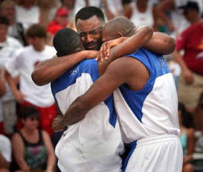
Team Atlanta players are held by Jerome Shelton after defeating  Rock N Fire in last year's Men's Elite Division championship game.
 (File/ / The Spokesman-Review)