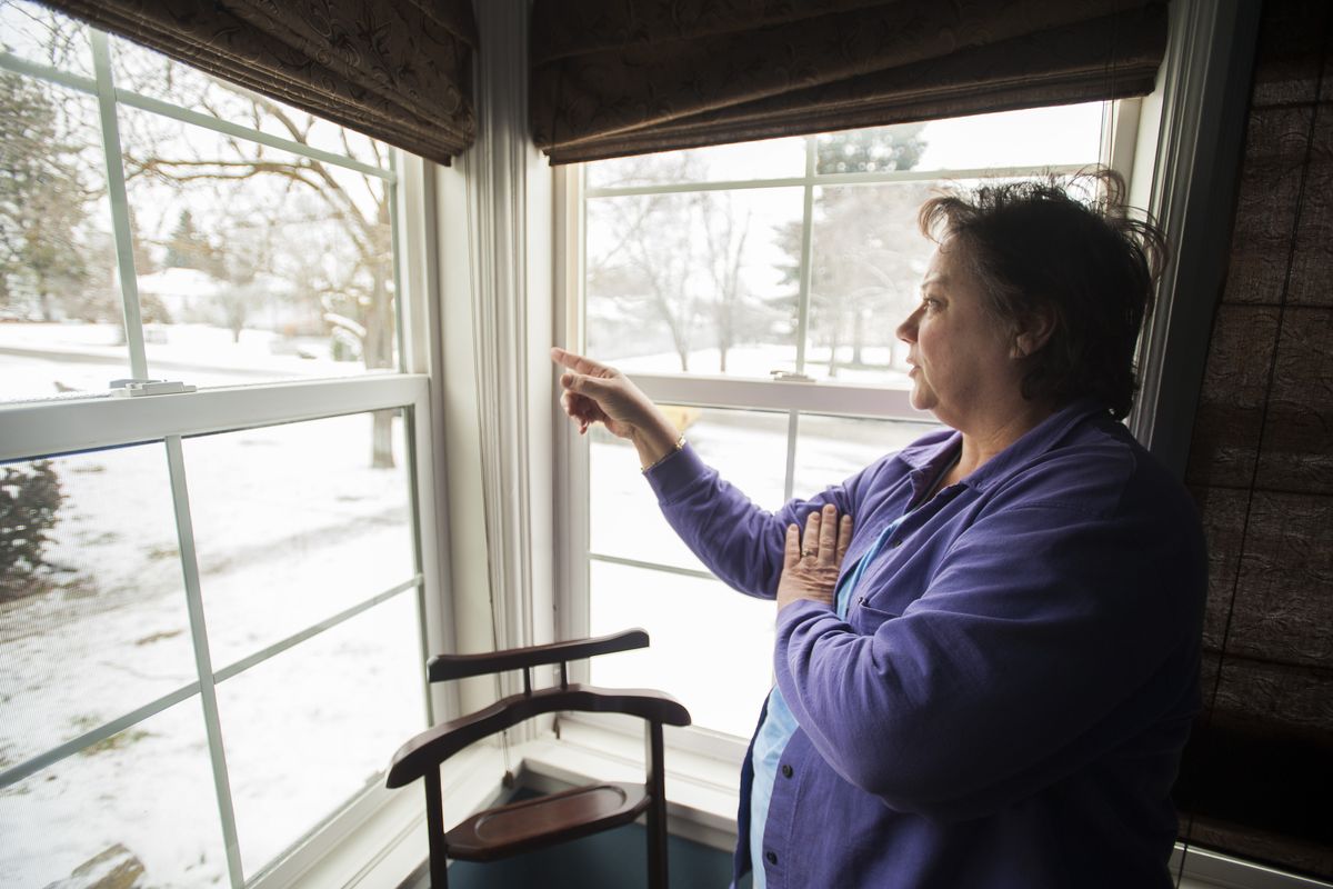 “This is where the party always is,” said Marie Schultz, pointing outside her bedroom window to the house next door where a woman was shot early New Year’s Day. Schultz said the house has been a chronic nuisance for more than two years. (Colin Mulvany)