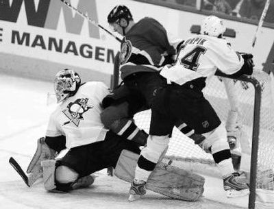 Ottawa's Christoph Schubert is caught between Pittsburgh goalie Marc-Andre Fleury and defenseman Brooks Orpik.
 (Associated Press / The Spokesman-Review)