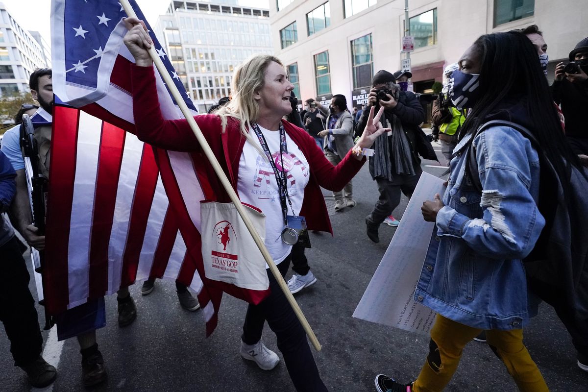 A woman gestures as she argues with a counter-protester after supporters of President Donald Trump held marches Saturday, Nov. 14, 2020, in Washington.  (Julio Cortez)
