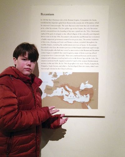 This photo provided by Joanne Lerman shows her son Benjamin Lerman, posing by an inaccurate map at the Metropolitan Museum of Art in New York. (Associated Press)