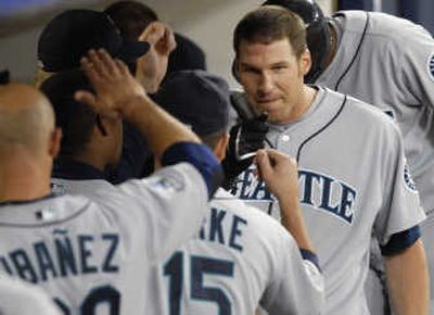 Richie Sexson's homer earns kudos from Raul Ibanez, left, and Jamie Burke. Associated Press
(Associated Press / The Spokesman-Review)