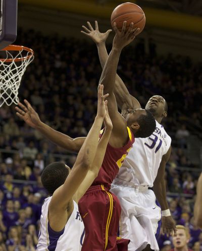Huskies Abdul Gaddy, left, and Terrence Ross apply pressure to Byron Wesley. (Associated Press)