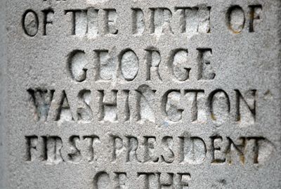 Vandals have chipped away at the inscription on the George Washington monument in Manito Park.  (Jesse Tinsley / The Spokesman-Review)