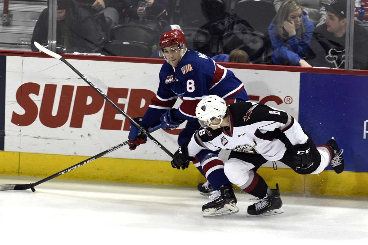 Spokane Chiefs forward Jake McGrew (8) and Vancouver Giants forward Dylan Plouffe (6) compete for control of the puck during the second period of a WHL hockey game, Friday, March 8, 2019 in the Spokane Arena. (Colin Mulvany / The Spokesman-Review)