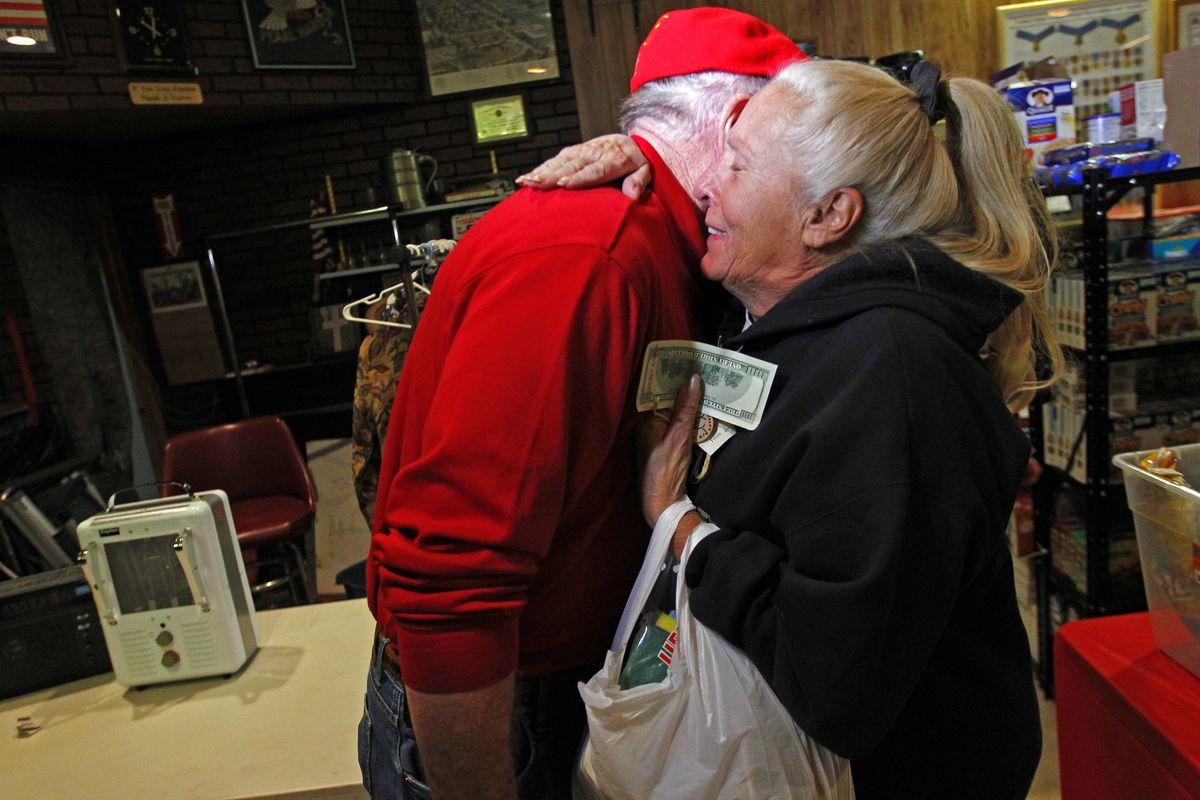 Carol Hefty hugs Secret Santa after he gave her a $100 dollar bill while she was looking for supplies at a temporary supply house at the Oakwood Heights VFW Post 9587 in the boro of Staten Island, New York, N.Y., Thursday, Nov. 29, 2012. The wealthy philanthropist from Kansas City, Mo. Secret Santa distributed $100 dollar bills to needy people at several locations in Elizabeth, N.J. and Staten Island. (Rich Schultz / Fr27227 Ap)