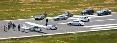 Police officers and vehicles surround a Cessna 150 airplane that was forced to land at the Frederick, Md., airport on Wednesday after it entered restricted airspace and came within three miles of the White House.
(Associated Press / The Spokesman-Review)