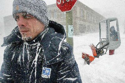 
U.S. postal workers Michael Nunes, left, and Shane Swansey clear the sidewalks around the New Bedford, Mass., main post office. 
 (Associated Press / The Spokesman-Review)