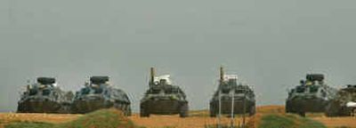 Syrian armored vehicles are seen east of Beirut, Lebanon, on Sunday. Syria agreed to remove its troops from Lebanon by April 30, a U.N. envoy said Sunday.
(Associated Press / The Spokesman-Review)