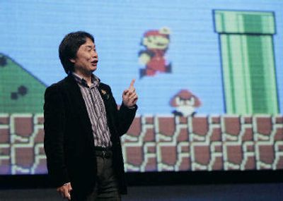 
Shigeru Miyamoto, Nintendo Co.'s top game designer, gives a keynote address as the game Mario Brothers plays in background at the Game Developer Conference in San Francisco on Thursday. 
 (Associated Press / The Spokesman-Review)