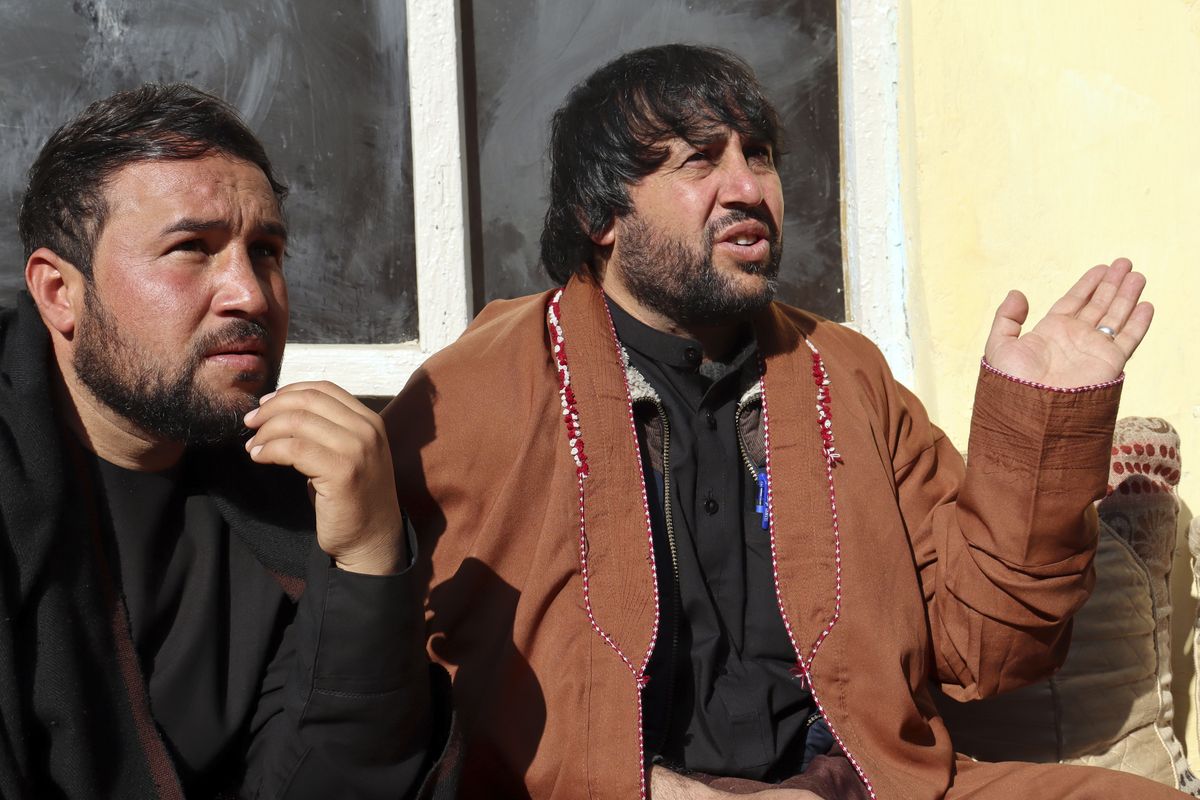 Ajmal Ahmadi, right, a brother of Zemerai Ahmadi, who was one of ten family members who was killed in an errant U.S. drone strike in August, speaks during an interview with The Associated Press at the Ahmadi family home, in Kabul, Afghanistan, Tuesday, Dec. 14, 2021. The Afghan survivors of the U.S. drone strike said Tuesday they are frustrated and saddened by a decision that no U.S. troops involved in the strike would face disciplinary action.  (Khwaja Tawfiq Sediqi)
