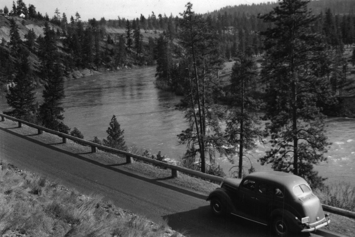 A car travels along the Spokane River on Downriver Drive, which turns into the Aubrey L. White Parkway through nearby Riverside State Park, in 1948. White (1869-1948) was a tireless crusader for bigger and better parks for the city of Spokane and was the city’s park board director from 1907 to 1921. (David C. Guilbert / Washington Department of Conservation and Development)