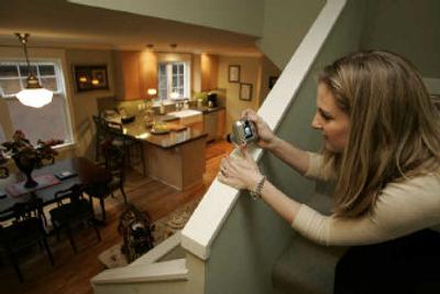 
Coldwell Banker Real Estate Agent Megan McGrath Glouner takes photos at the home of her client Molly Bolanos. Glouner will be marketing as well as looking on line with Bolanos and her fiancé Jeff Wilmot in Seattle. 
 (Associated Press / The Spokesman-Review)