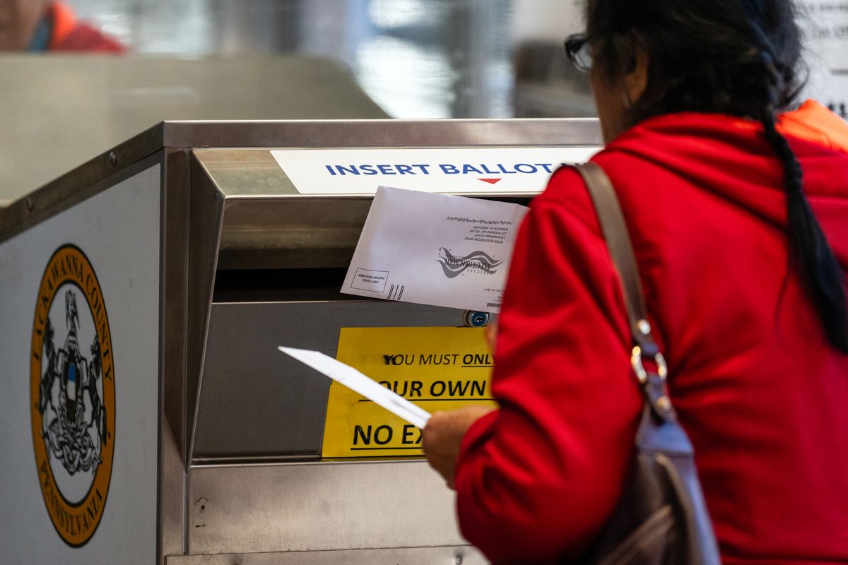 FILE -- A woman deposits a mail-in ballot at the Lackawanna County Government Center in Scranton, Pa., on Election Day, Tuesday, Nov. 5, 2024. The use of mail-in ballots surged during the COVID-19 pandemic. (Eric Lee/The New York Times)  (ERIC LEE)