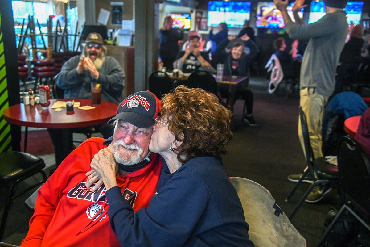 Jackie Crane has a victory kiss for her boyfriend Ken Briggs as they watch Gonzaga defeat Oklahoma from The Swinging Doors in a second-round game in the NCAA men’s college basketball tournament, Monday, March 22, 2021.  (DAN PELLE/THE SPOKESMAN-REVIEW)