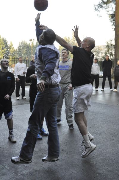 OLYMPIA -- Gov. Jay Inslee goes up for a rebound in an Inauguration Day pickup basketball game at a hoop set up on the garage of the Governor's Mansion (Jim Camden)