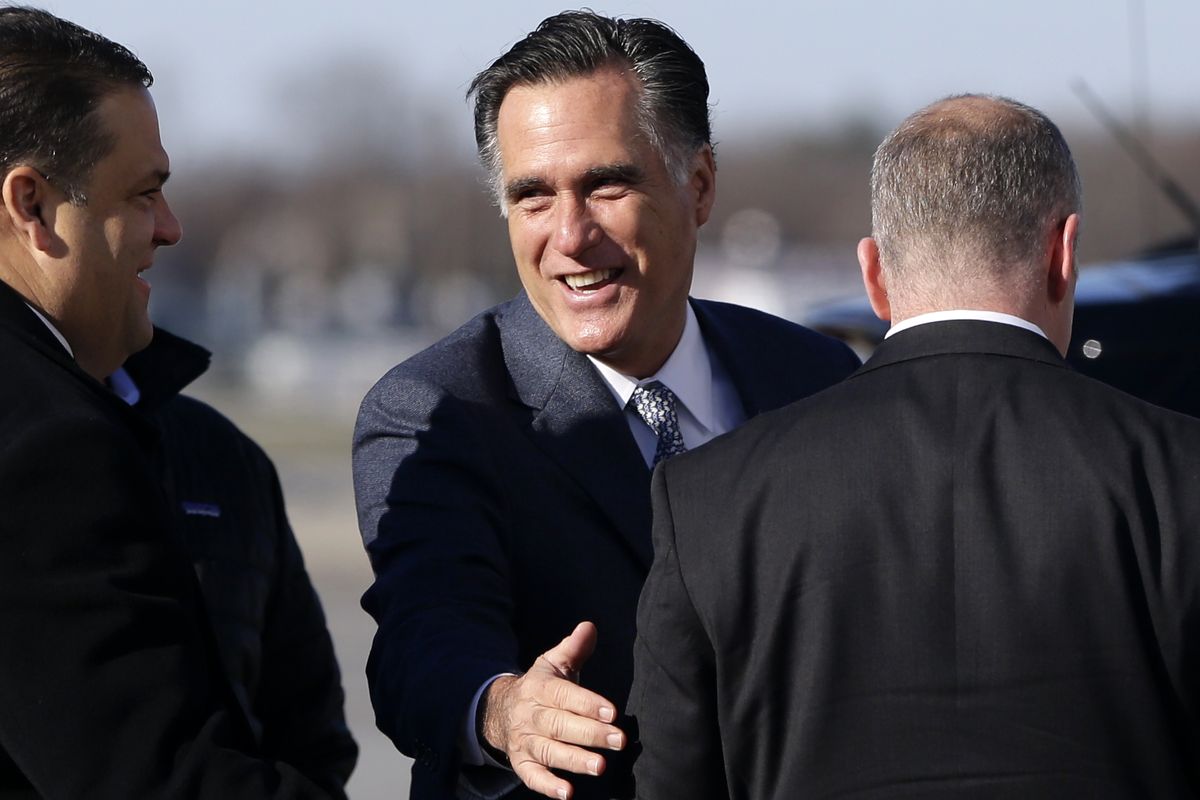 Republican presidential candidate, former Massachusetts Gov. Mitt Romney smiles as he speaks to a U.S. Secret Service agent before boarding his plane in Bedford Mass., for Cleveland, Ohio, Tuesday, Nov. 6, 2012. (Charles Dharapak / Associated Press)