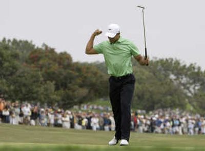 
Tiger Woods is charging after sinking a 25-foot birdie putt on the fourth hole. Woods made four birdies for a 30 on the back nine. Associated Press
 (Associated Press / The Spokesman-Review)