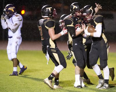 University’s Gage Anderson, right, is congratulated in the end zone after a score against Hanford on Thursday. (Jesse Tinsley)