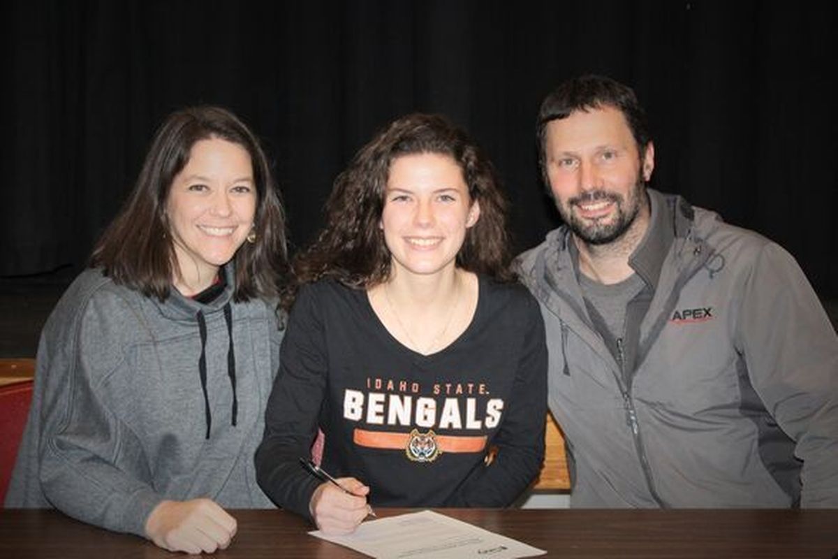 {span}Davenport multi-sport standout Darby Soliday signs her letter of intent to run track and field at Idaho State University. Her mother, Stacia Soliday, left and father Monty Soliday, right, coach Darby in basketball and soccer at Davenport.{/span}  (Courtesy of Soliday family)