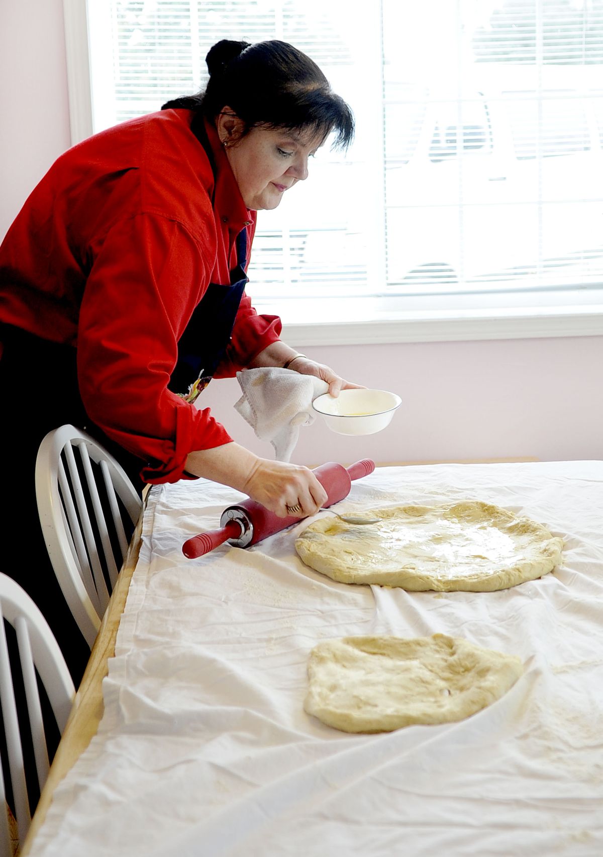 Karen Hood prepares the dough for her Eastern European walnut roll at her Greenacres home. Hood’s holiday-themed cookbook “Christmas Delights” is available in print and via download. (Kathy Plonka)