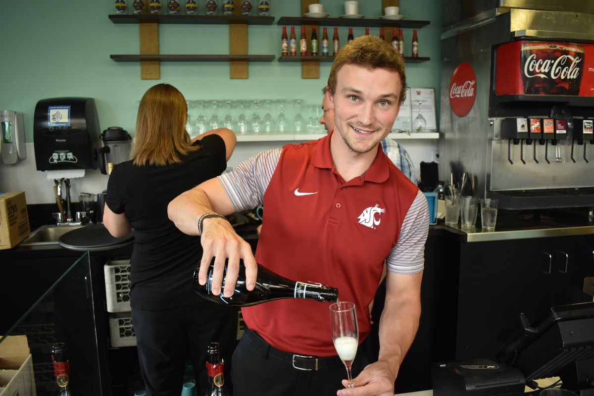 Tyler Stevenson pours champagne during the Birds and Bubbles dinner at the Yards Bruncheon in Kendall Yards on Thursday, Aug. 8, 2019. (Don  Chareunsy / The Spokesman-Review)