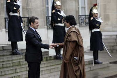 
French President Nicolas Sarkozy, left, greets Col. Moammar Gadhafi on Monday upon his arrival at the Elysee Palace in Paris. Associated Press
 (Associated Press / The Spokesman-Review)