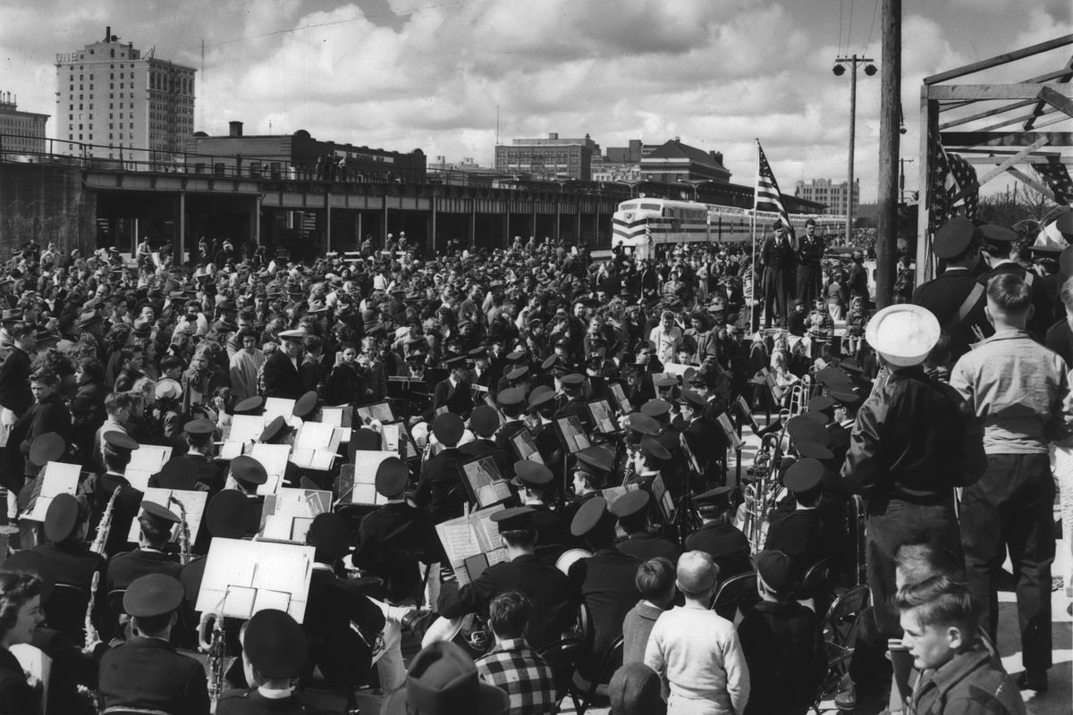 1948: Thousands wait in line while a brass band plays at the opening of the Freedom Train on April 13, 1948, on the Great Northern Railway train tracks in Spokane. Some 650 musicians entertain those waiting in line with patriotic and concert music throughout the long day. The traveling museum about American history toured every one of the 48 states from September 1947 to January 1949.  (Spokesman-Review photo archives)
