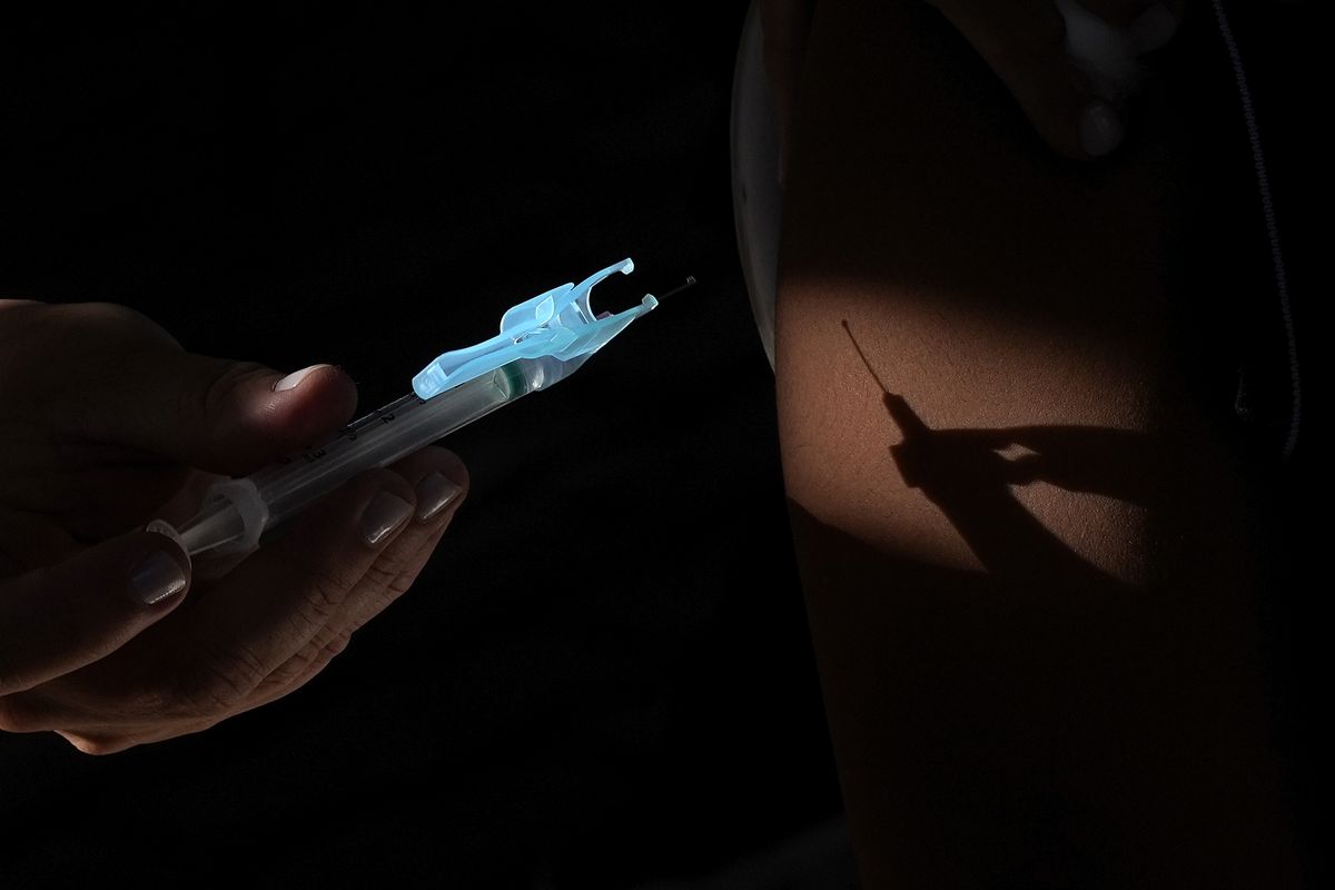 A health worker applies a shot of the Pfizer COVID-19 vaccine at a community health center in Brasilia, Brazil, Sunday, Jan. 16, 2022. Brasilia started the COVID-19 vaccination of children between ages 5 and 11.  (Eraldo Peres)
