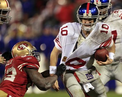 New York Giants quarterback Eli Manning is sacked by San Francisco 49ers' Patrick Willis. (Associated Press)