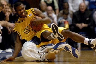 
Kent State's Chris Singletary trips over Duke's Jon Scheyer during the first half of Tuesday's game at Durham, N.C. 
 (Associated Press / The Spokesman-Review)