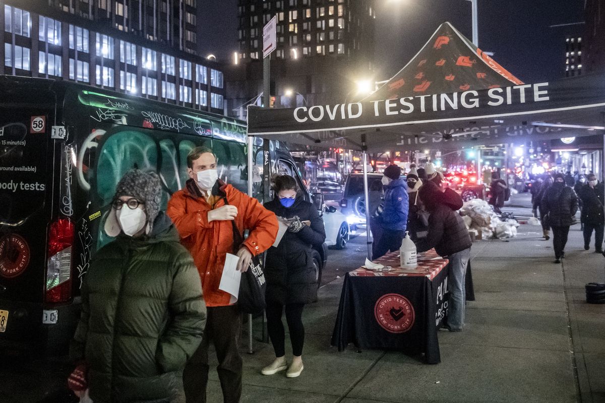People wait on line to get tested for COVID-19 on the Lower East Side of Manhattan, Tuesday, Dec. 21, 2021, in New York.  (Brittainy Newman)