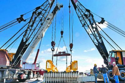 Workers prepare to move a piece of the Tacoma Narrows Bridge on Tuesday. The piece has been stalled since March 17 for not meeting state weight rules.
(Jed Conklin / The Spokesman-Review)
