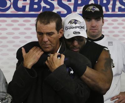 Ravens owner Stephen J. Bisciotti gets a victory hug from Ray Lewis. (Associated Press)