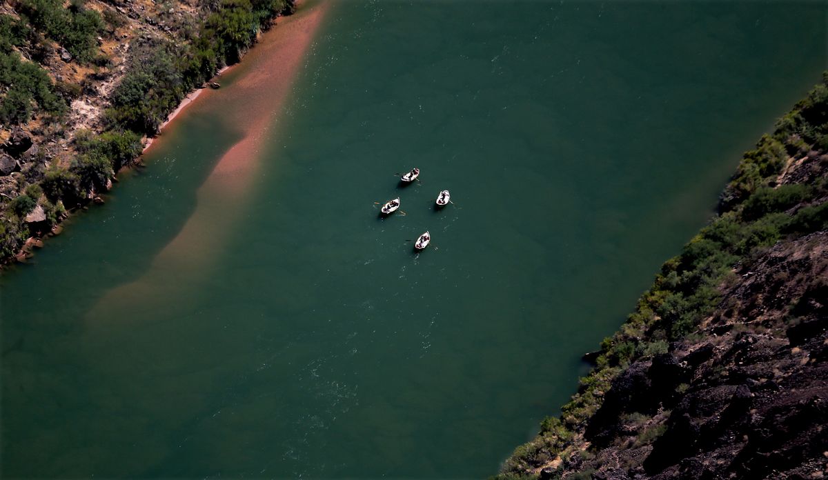 Whitewater river rafters are dwarfed on the Colorado River as seen from Toroweap Overlook on the north rim of the Grand Canyon. (Luis Sinco/Los Angeles Times/TNS)