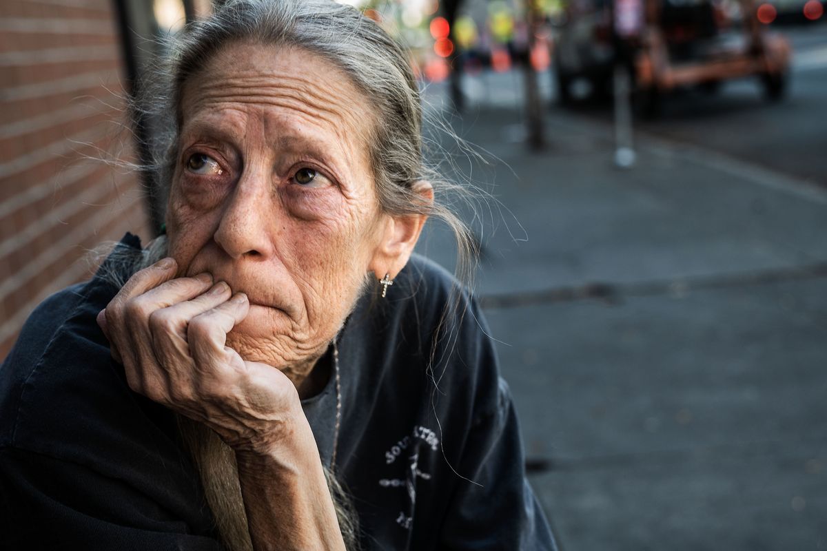 Ridpath Club Apartments resident Rhona Gardener sits outside on the sidewalk as she explains that more affluent people in the area call the Ridpath “Camp Dope.” (COLIN MULVANY/THE SPOKESMAN-REVIEW)