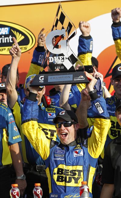 Matt Kenseth, lifting trophy, and Tony Stewart won the two qualifying races at Daytona on Thursday. (Associated Press)
