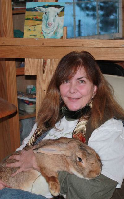 Kit Jagoda poses with a rabbit named Albrecht in her studio in a loft above the bunny barn at her home in the Seven Mile area. 